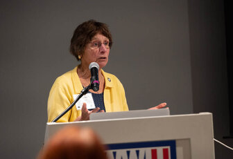 Carla Fortmann speaking at podium