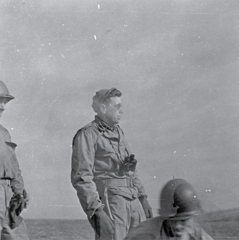 uniformed man with binoculars hanging around his neck