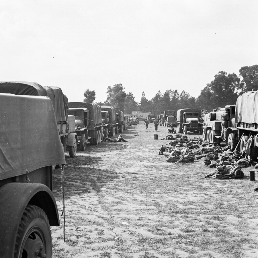 Soldier supplies lying on the ground near trucks