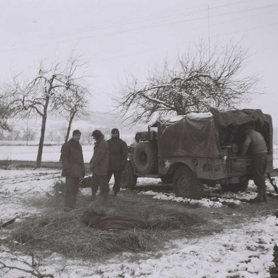 Soldiers outside a truck in a snowy location