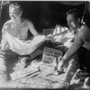 two men with papers in front of tent 1944