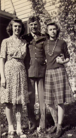 Harold J Dahl posing in army uniform with two women
