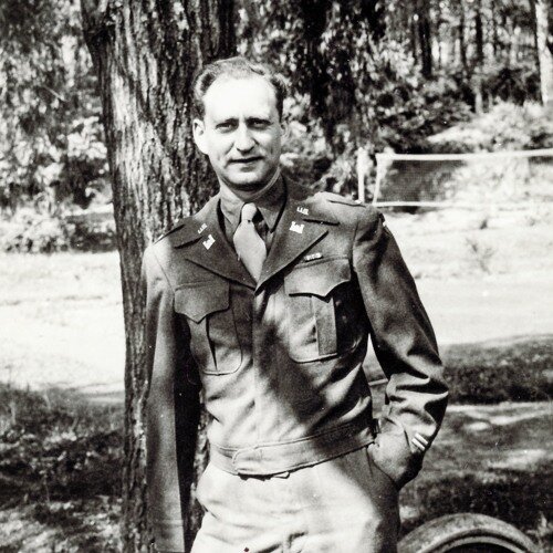 Gil Seltzer standing by a Jeep in World War 2