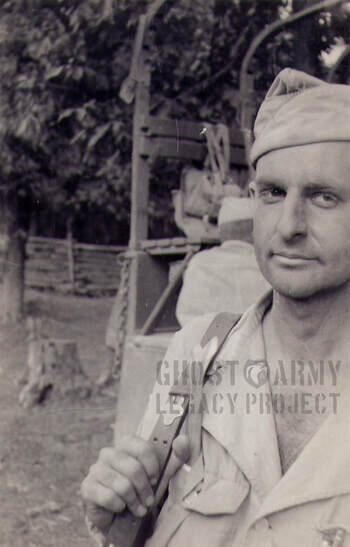 close up of soldier with pack in front of wooden ropes structure