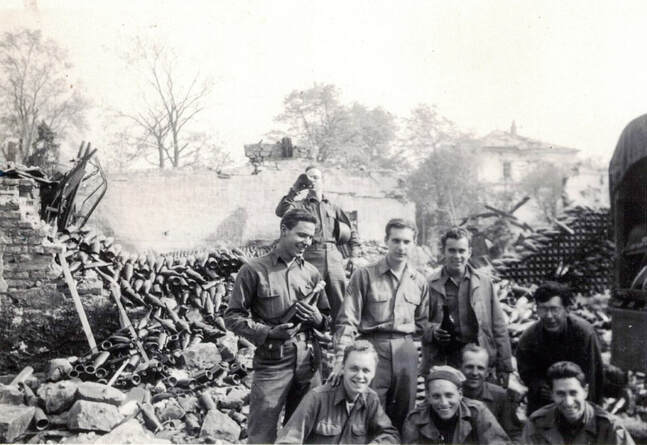 Soldiers posing for a photo in the bombed out remains of a French factory WW2