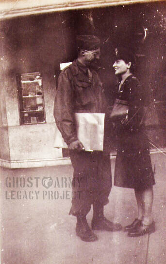 soldier and army nurse standing by a box office ww2