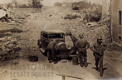 soldiers surrounding a truck on a dirt road