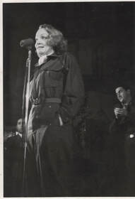 Marlene Dietrich at a microphone