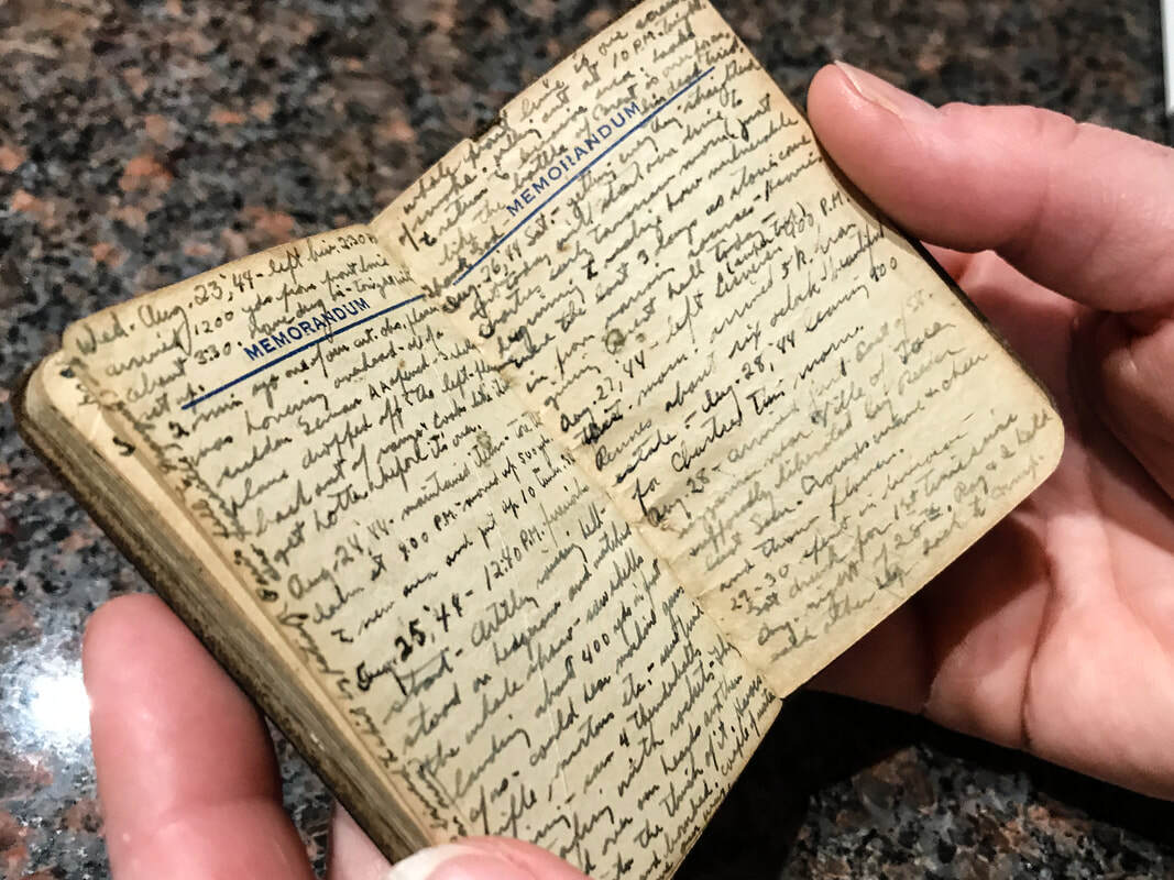a small diary held over marble table top